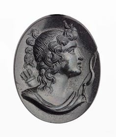 Diosa griega Artemisa con una masa de rizos a lo largo de su rostro que fluyen por su cuello.